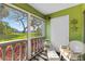 Sunroom with large windows overlooking landscaped yard at 1250 S Pinellas Ave # 405, Tarpon Springs, FL 34689