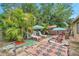 Landscaped backyard featuring brick pavers, multiple seating areas, tropical landscaping and a shed at 12790 118Th St, Seminole, FL 33778