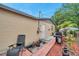 Backyard exterior featuring a grill, seating, tidy landscaping, and exterior access at 12790 118Th St, Seminole, FL 33778