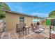 Backyard patio area featuring brick pavers, outdoor seating, shade umbrella, and tidy exterior at 12790 118Th St, Seminole, FL 33778
