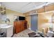 Basement Laundry area features tile floors, tv, dresser, and storage area at 12790 118Th St, Seminole, FL 33778