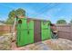 Backyard shed with exterior storage featuring a variety of yard tools and equipment at 12790 118Th St, Seminole, FL 33778