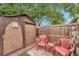 Backyard shed with covered patio featuring casual seating, privacy fence, and mature trees at 12790 118Th St, Seminole, FL 33778