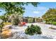 Expansive backyard featuring a screened lanai, fire pit, mature trees, and ample space for outdoor activities and relaxation at 1403 Garden Ave, Tarpon Springs, FL 34689