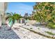 Well-maintained backyard with a storage shed, accent wall, lush greenery, decorative rock, and a serene atmosphere at 1403 Garden Ave, Tarpon Springs, FL 34689
