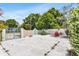 Backyard patio with gate and chairs offers a private space at 1403 Garden Ave, Tarpon Springs, FL 34689