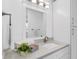 Clean bathroom with a white vanity, ample storage, and modern lighting at 1403 Garden Ave, Tarpon Springs, FL 34689