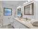 Bright bathroom with a double sink vanity, modern fixtures, and well-lit mirrors at 1403 Garden Ave, Tarpon Springs, FL 34689