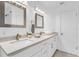 Well-lit bathroom with double sinks, white cabinetry, and modern fixtures at 1403 Garden Ave, Tarpon Springs, FL 34689