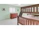 Fun bedroom with a wooden bunk bed, light green walls, and a colorful dresser at 1403 Garden Ave, Tarpon Springs, FL 34689