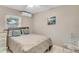 Cozy bedroom with a queen-sized bed, modern decor, and a bright window at 1403 Garden Ave, Tarpon Springs, FL 34689