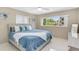 Bright bedroom with a comfortable bed, soft bedding, and sunny window views at 1403 Garden Ave, Tarpon Springs, FL 34689