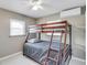 Bedroom with a wooden bunk bed frame, light grey walls, and tiled flooring at 1403 Garden Ave, Tarpon Springs, FL 34689