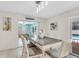 Dining area featuring a wooden table, chairs, and sliding door to the pool area at 1403 Garden Ave, Tarpon Springs, FL 34689