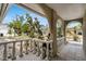 Charming front porch with arched entryways and a railing overlooking the landscaped front yard at 1403 Garden Ave, Tarpon Springs, FL 34689