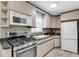 Bright kitchen featuring granite countertops, stainless steel appliances, and plenty of cabinet space at 1403 Garden Ave, Tarpon Springs, FL 34689