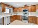Updated kitchen featuring stainless steel appliances, wooden cabinets, and tiled flooring at 1403 Garden Ave, Tarpon Springs, FL 34689