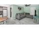 Open-concept living room featuring a sofa, tile flooring, and connecting to the dining room and kitchen at 1403 Garden Ave, Tarpon Springs, FL 34689