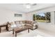 Comfortable living room with neutral tones, large windows, and an inviting sectional sofa at 1403 Garden Ave, Tarpon Springs, FL 34689