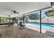 Covered patio featuring a dining set, ceiling fans, and scenic views of the pool at 1403 Garden Ave, Tarpon Springs, FL 34689