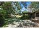 Well-maintained backyard features a screened-in porch and mature trees, offering ample shade at 14615 Daybreak Dr, Lutz, FL 33559
