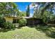 Backyard features a screened-in porch, mature landscaping and a well maintained lawn at 14615 Daybreak Dr, Lutz, FL 33559