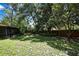 Well-maintained backyard with lush greenery and mature trees, providing a tranquil outdoor space at 14615 Daybreak Dr, Lutz, FL 33559