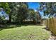 Expansive backyard with lush lawn and mature trees offers a serene outdoor oasis at 14615 Daybreak Dr, Lutz, FL 33559