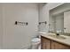 Bathroom featuring a vanity and sink with a mirror, accompanied by a toilet at 14615 Daybreak Dr, Lutz, FL 33559
