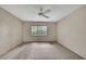 Bright bedroom featuring a window with blinds and neutral-toned walls at 14615 Daybreak Dr, Lutz, FL 33559