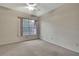 Bedroom with natural light streaming in from a window and plush carpeting at 14615 Daybreak Dr, Lutz, FL 33559