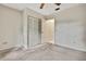 Bright bedroom features neutral carpet, ceiling fan and an adjacent closet space, offering comfort and storage at 14615 Daybreak Dr, Lutz, FL 33559