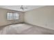 Spacious bedroom featuring neutral walls, plush carpeting, and a ceiling fan at 14615 Daybreak Dr, Lutz, FL 33559