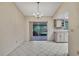 Dining room with tile flooring, chandelier lighting, and sliding glass doors to the outside at 14615 Daybreak Dr, Lutz, FL 33559