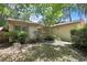 Exterior of home featuring mature landscaping, large shrubbery, and a well maintained lawn at 14615 Daybreak Dr, Lutz, FL 33559