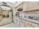 Kitchen features white cabinets, matching appliances, and archway to dining area at 14615 Daybreak Dr, Lutz, FL 33559