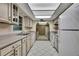 Well-lit kitchen with tile floors, neutral countertops, and white appliances at 14615 Daybreak Dr, Lutz, FL 33559