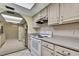 Functional kitchen with white appliances, ample counter space, and tile flooring at 14615 Daybreak Dr, Lutz, FL 33559