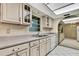 Spacious kitchen with tile floors, neutral countertops, and ample cabinet storage at 14615 Daybreak Dr, Lutz, FL 33559