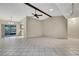 Spacious living room featuring tile flooring, neutral paint, and a modern ceiling fan at 14615 Daybreak Dr, Lutz, FL 33559