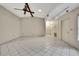 Large living room with tile floors, ample lighting, and convenient access to other rooms at 14615 Daybreak Dr, Lutz, FL 33559