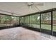 Relaxing screened patio, perfect for outdoor living and enjoying the lush backyard views with ceiling fan at 14615 Daybreak Dr, Lutz, FL 33559