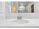 Close-up view of bathroom sink with chrome faucet and quartz countertop at 15062 Hummingbird Rd, Weeki Wachee, FL 34614