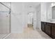Bathroom with shower, tile floors, and vanity, with an open doorway to another room at 15062 Hummingbird Rd, Weeki Wachee, FL 34614
