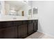 Bathroom featuring a double sink vanity with dark wood cabinets and tile flooring at 15062 Hummingbird Rd, Weeki Wachee, FL 34614