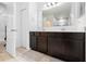 Bathroom featuring a double sink vanity with dark wood cabinets and tile flooring at 15062 Hummingbird Rd, Weeki Wachee, FL 34614