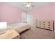 Cozy bedroom featuring neutral colors, a dresser, and a ceiling fan at 15062 Hummingbird Rd, Weeki Wachee, FL 34614