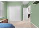 Bright bedroom featuring a large closet, neutral carpet and a doorway to another room at 15062 Hummingbird Rd, Weeki Wachee, FL 34614