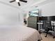 Bright bedroom featuring a ceiling fan, a dresser with a TV, and a dedicated workspace at 15062 Hummingbird Rd, Weeki Wachee, FL 34614