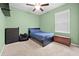 Well-lit bedroom with neutral carpet, ceiling fan and a comfortable-looking bed at 15062 Hummingbird Rd, Weeki Wachee, FL 34614